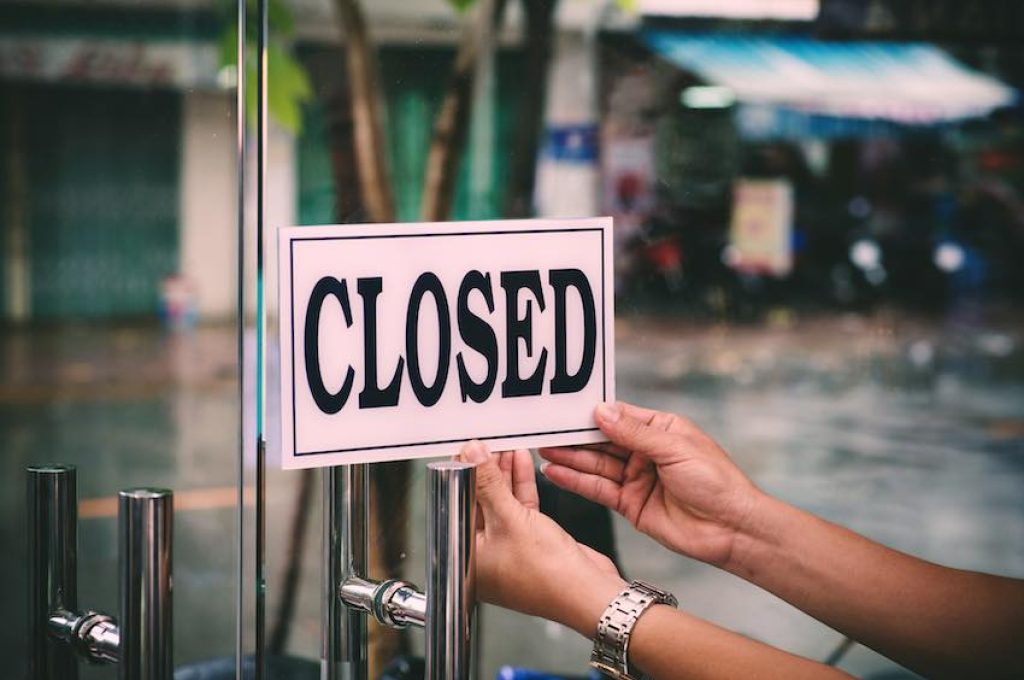 Hands of hairstylist closing barbershop in the evening